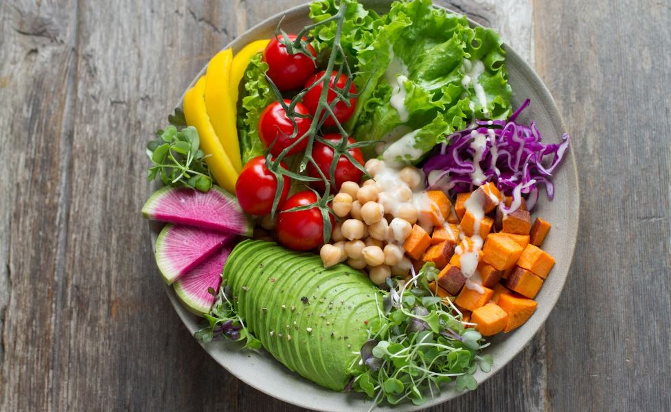 vegetable in a bowl with wooden table background