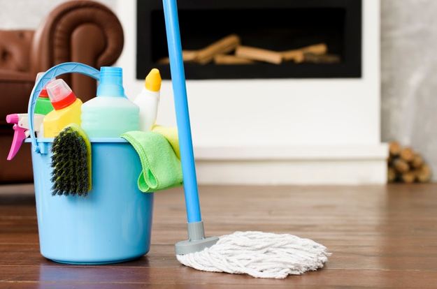 A close-up picture focusing on a set of cleaning products and supplies on the floor