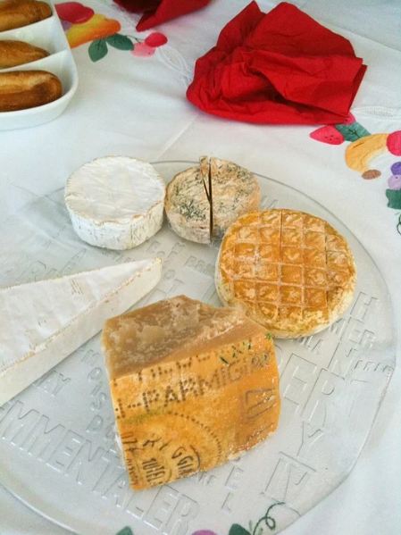 An image of cheese on a plain cheese board