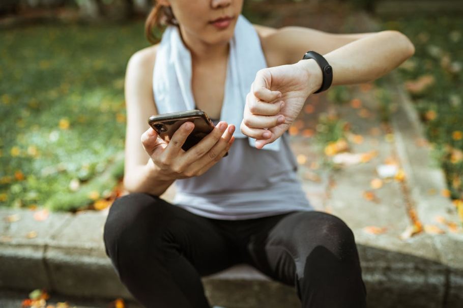 Girl using smartphone after exercise