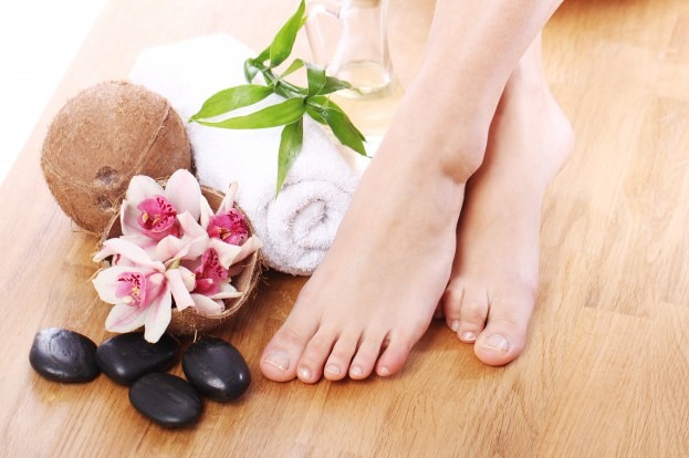 Legs and feet of a woman with different spa items