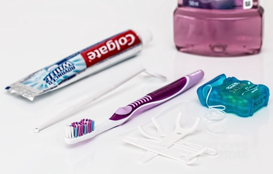 a toothbrush, toothpaste, and dental floss