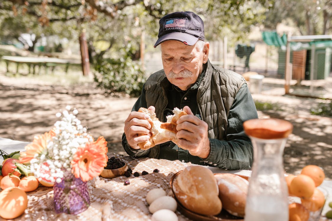 old man eating bread